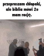 a group of people standing next to each other in a room .
