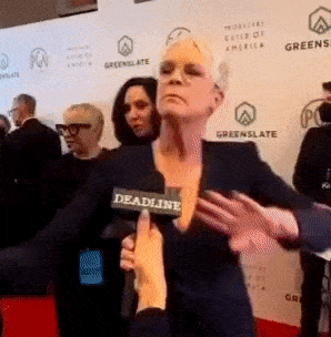 a woman is holding a microphone that says deadline
