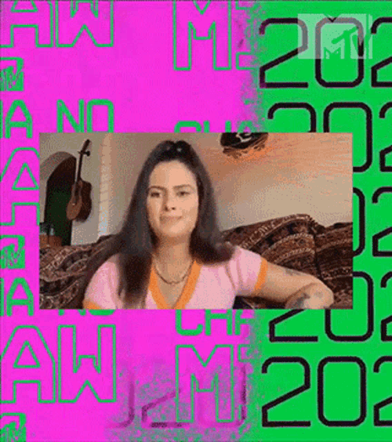a woman is sitting on a couch in front of a pink and green background with the year written on it .