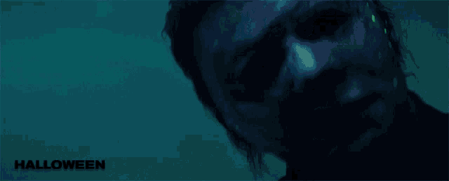 a close up of a man 's face with the word halloween on the bottom right