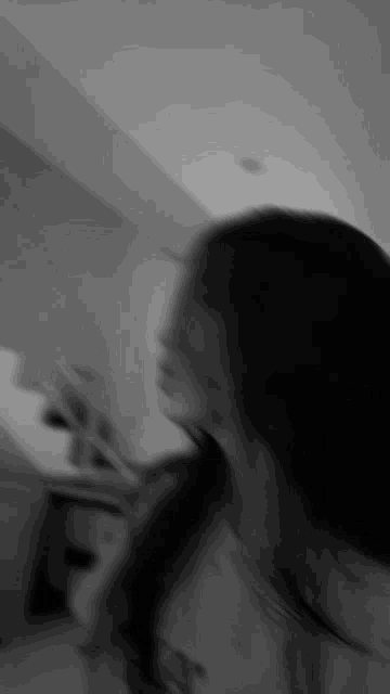 a blurry black and white photo of a woman