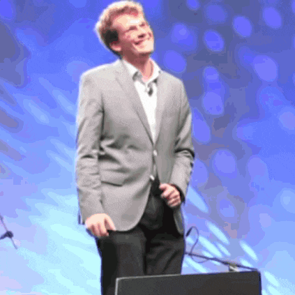a man in a suit is standing in front of a podium