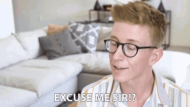 a young man wearing glasses says excuse me sir