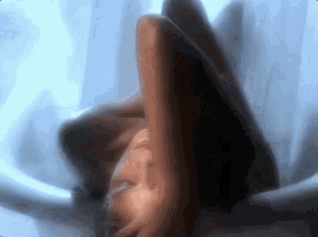 a blurry picture of a person laying on their back with their arms outstretched