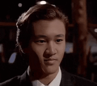 a man in a suit and tie is smiling at the camera .