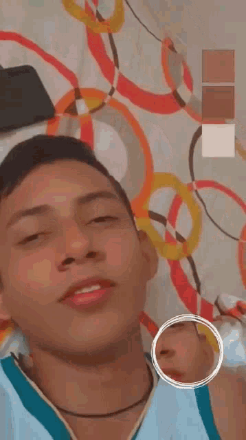 a man is laying on a bed with his mouth open and a circle around his face .