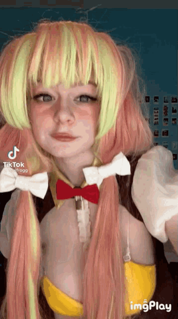 a woman wearing a wig and a bow tie .