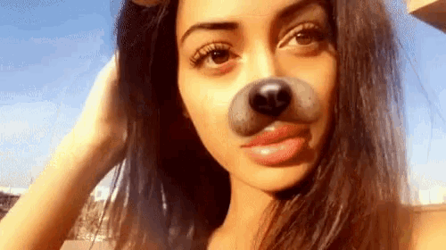 a woman wearing a fake dog nose on her face