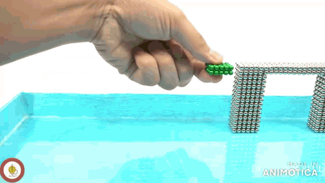 a person is playing with a bridge made out of magnets