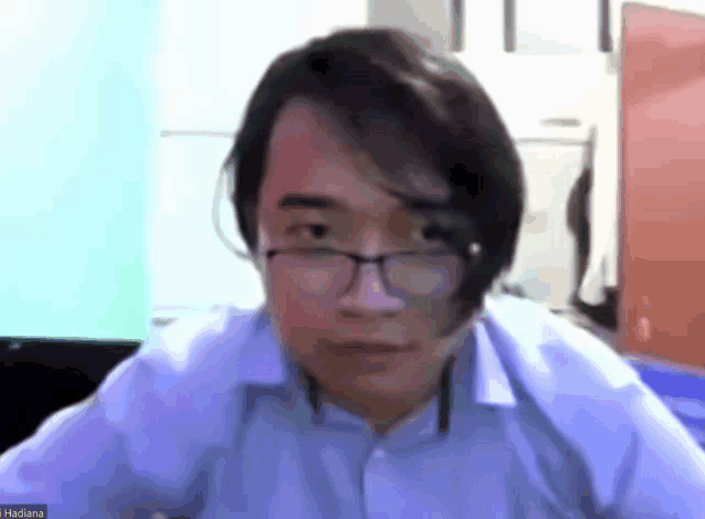 a man wearing glasses is on a video call with the name hadiana at the bottom of the screen