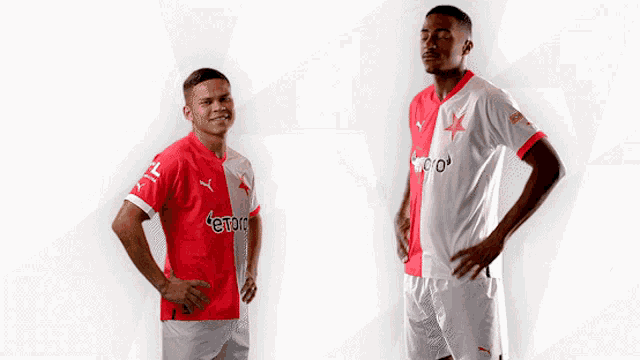 two soccer players shaking hands with one wearing a shirt that says toro on it