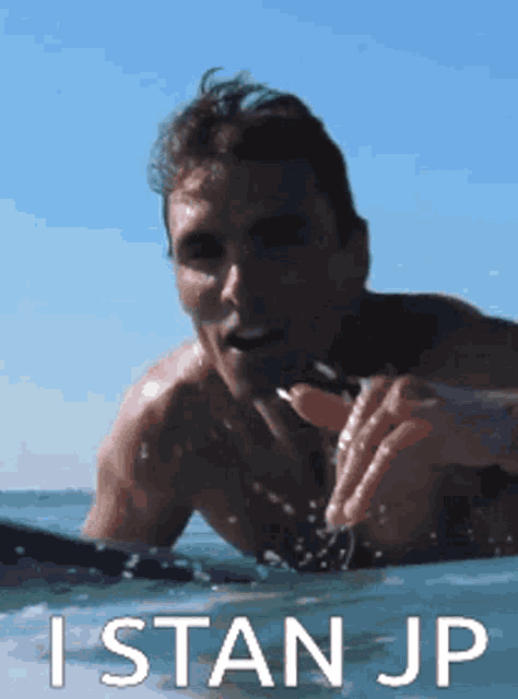 a shirtless man is swimming in the ocean with the words istanjp written below him