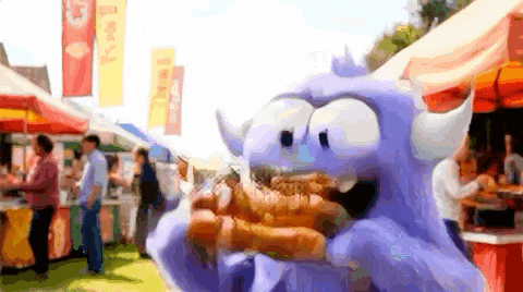 a cartoon monster is eating a hot dog at a festival