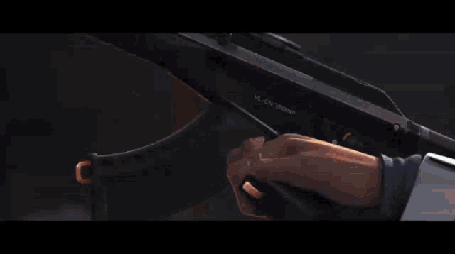 a close up of a person 's arm holding a gun