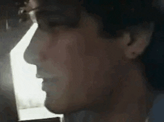 a close up of a person 's face with a blurred background .
