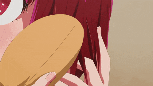 a woman with red hair is brushing her hair with a yellow brush