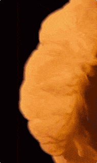 a close up of a yellow smoke coming out of a fire