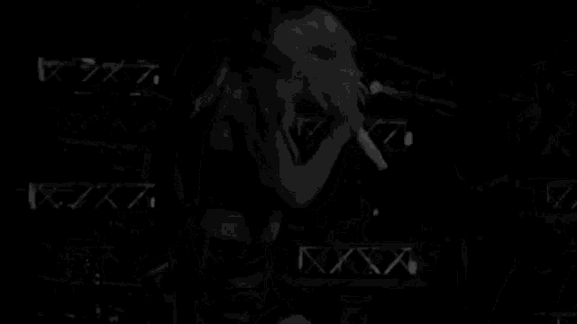 a woman is singing into a microphone on a stage .