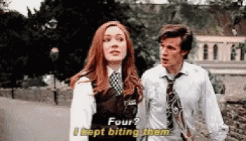 a man and a woman are standing next to each other and the woman is saying four i kept biting them