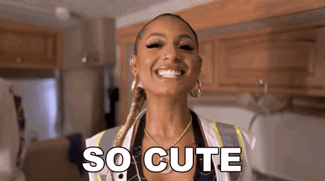 a woman is smiling and the words so cute are visible