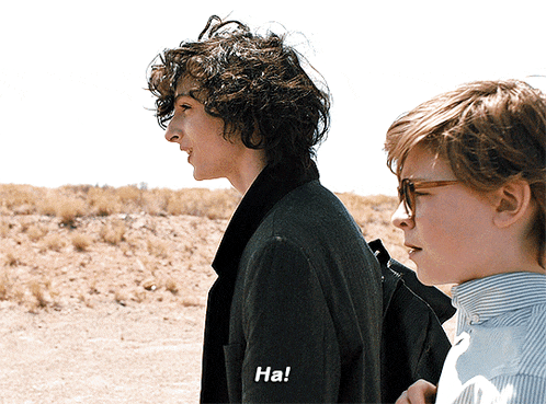two young men standing next to each other one of whom has the word ha on his sleeve