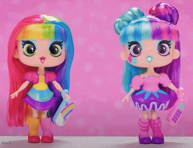 two dolls with colorful hair are standing next to each other on a pink background