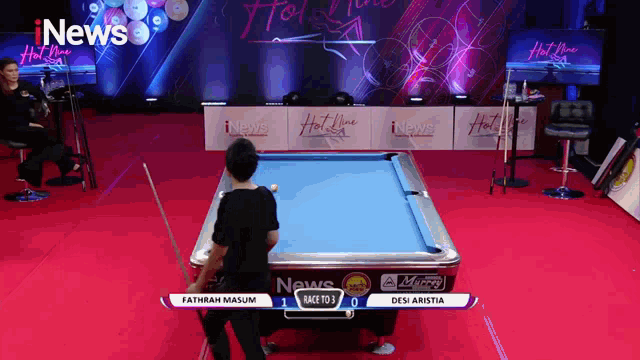 a pool table sponsored by inews is being played