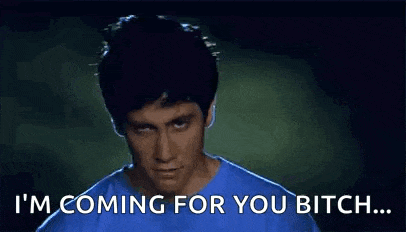 a man in a blue shirt is saying i 'm coming for you bitch .
