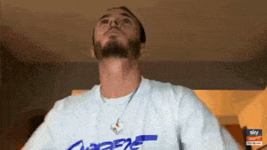 a man with a beard is wearing a white shirt that says dodgers