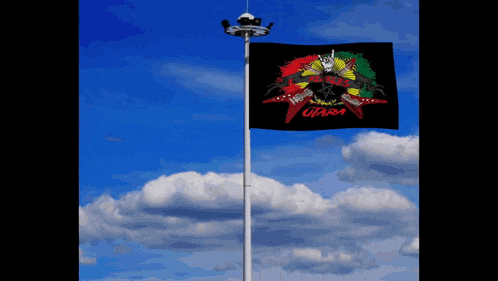 a flag on a pole that says utama on it