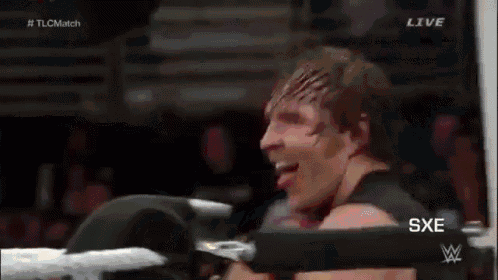 a man is sitting in a boxing ring with the word live on the bottom left