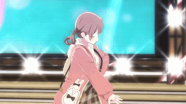 a girl in a pink jacket is standing on a stage in front of a blue background .