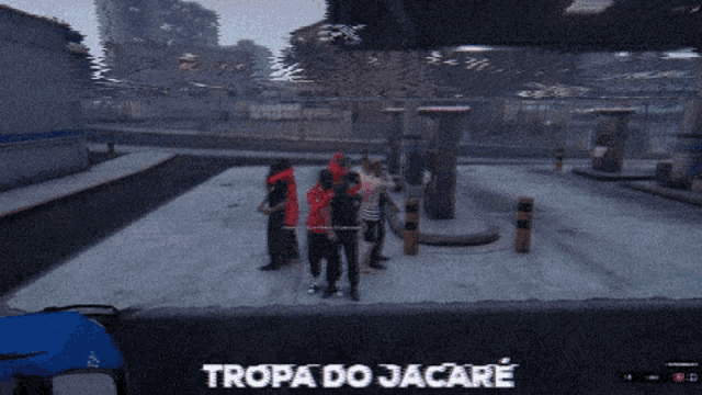 a group of people are standing in a parking lot and the words tropa do jacare are on the screen