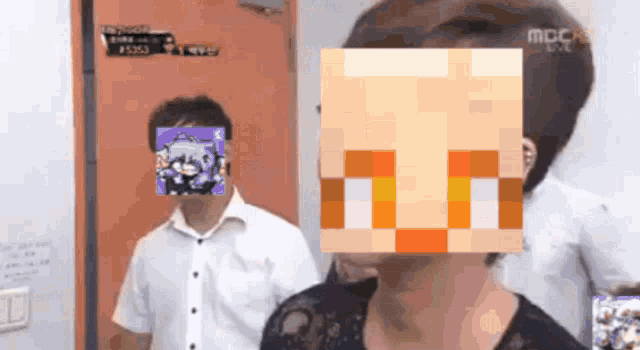 a man and a woman are standing next to each other with a pixelated face covering their faces