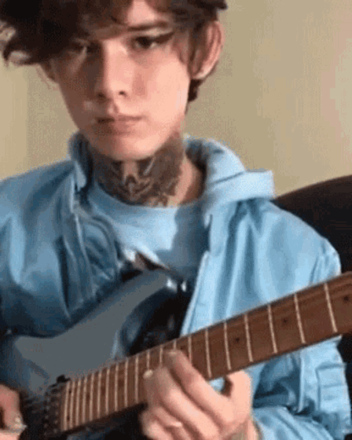 a young man is playing a guitar in a living room .