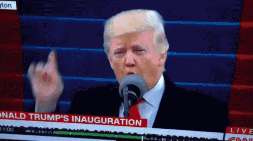 donald trump is giving a middle finger in front of a microphone