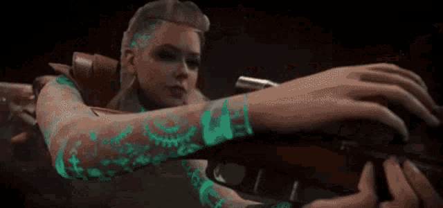 a woman is holding a gun and the words boom bitch are on the screen .