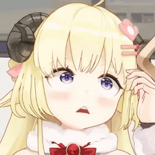 a close up of a girl with horns on her head making a funny face