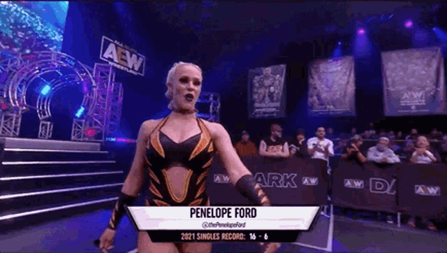 a female wrestler named penelope ford stands in front of a crowd