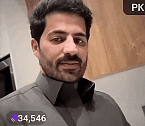 a man with a beard is wearing a gray shirt and has 34,546 followers