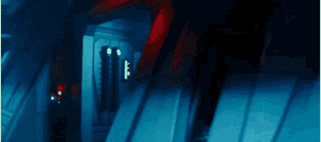 a person in a dark room with red lights