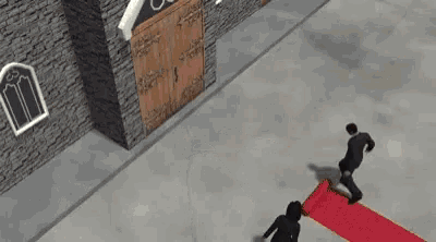 a man is rolling a red carpet in front of a building .