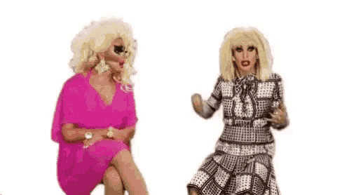 two drag queens are sitting next to each other and talking to each other on a white background .
