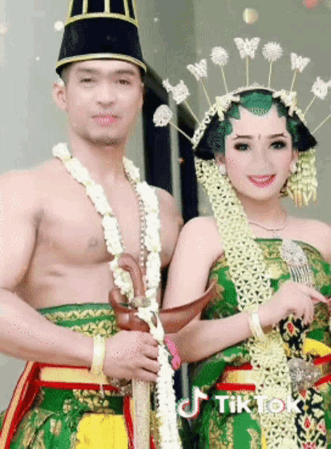 a man and a woman are posing for a picture with tiktok written in the corner