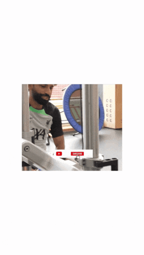 a man with a beard is standing in front of a machine that says push