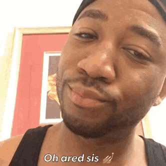 a man with a beard is smiling and saying oh ared sis