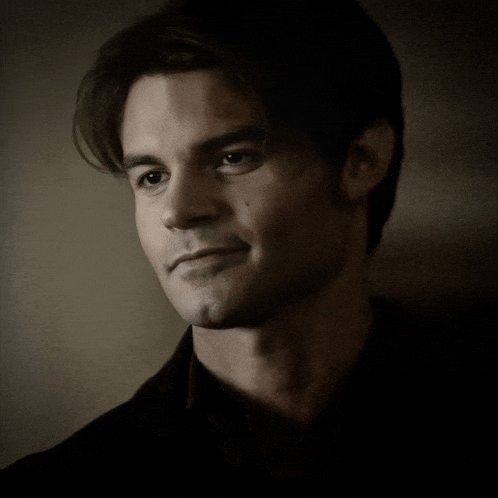 a close up of a man 's face with a smile on his face