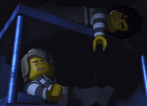 two lego characters are standing next to each other in a blue box