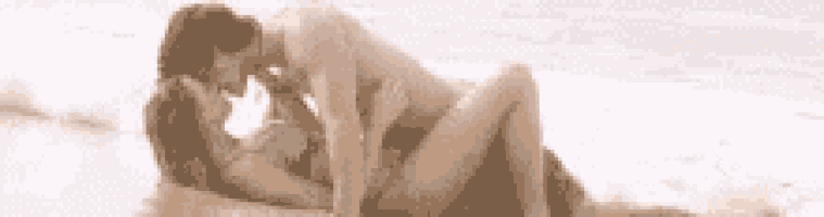 a man and woman are having sex on the beach .