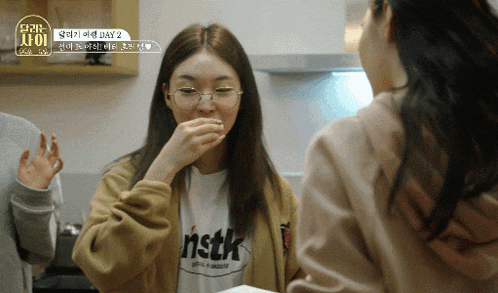 a girl wearing glasses and a shirt that says nstk on it